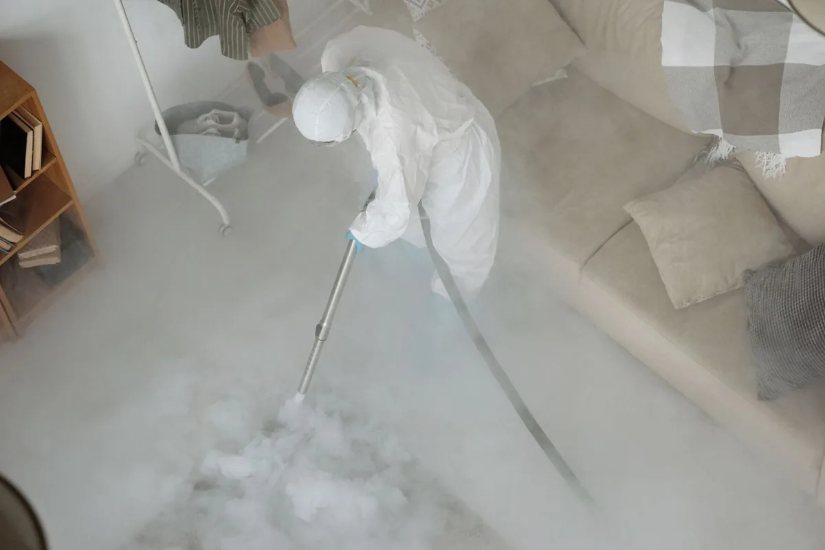 Biohazard cleanup technician in protective equipment, Rockwell, AR